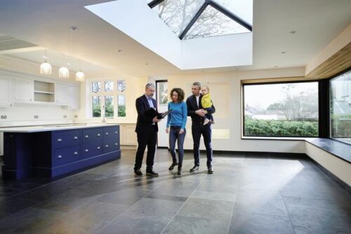 A real estate agent showing a family a home