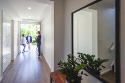 A real estate agent is showing a home